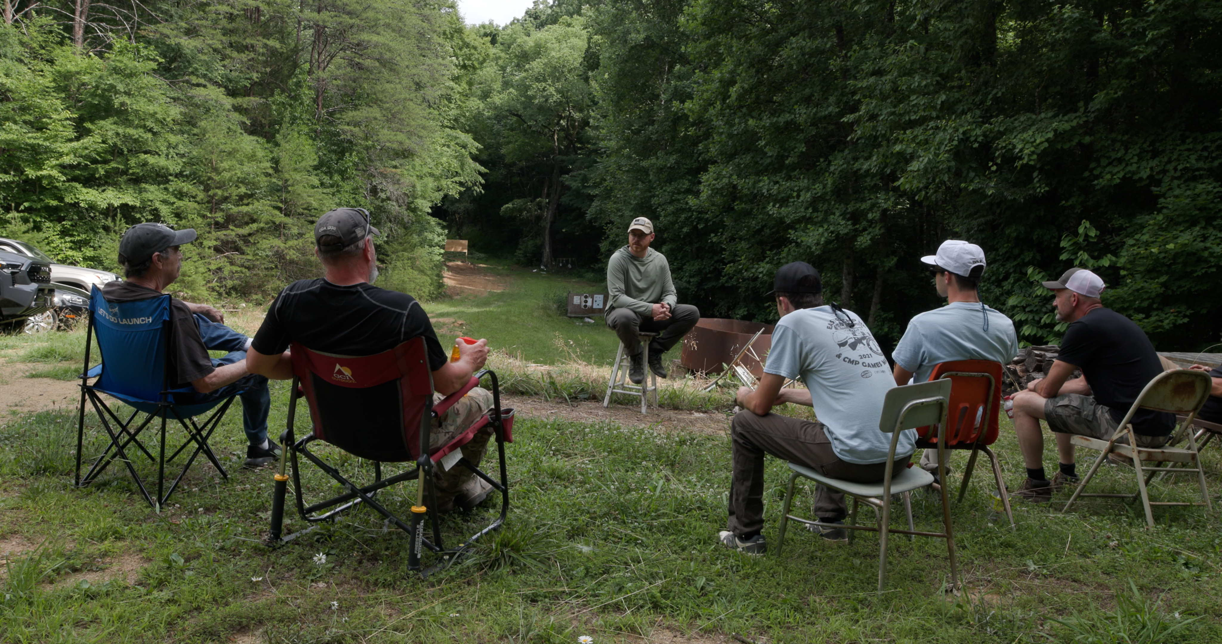 Group debrief circle at the range